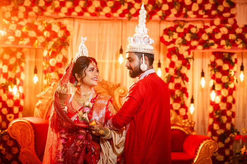 Elegant Bengali wedding with a couple in traditional attire, showcasing cultural beauty.